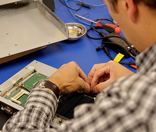 Teguar service technician fixing an industrial computer