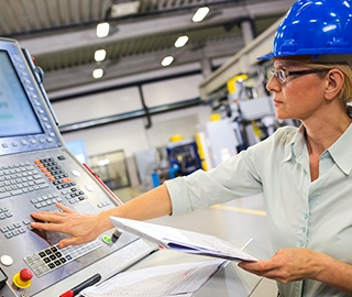 Warehouse technician using an industrial computer on the factory floor