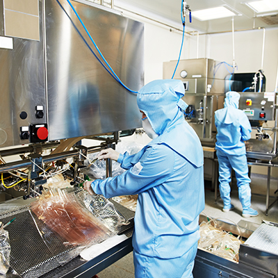 Employees operating machinery in a clean room