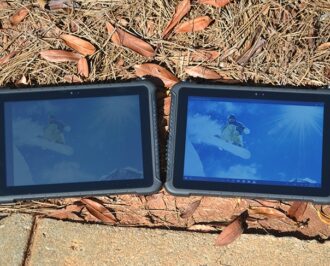 Two Teguar rugged tablets side by side outside showing high brightness model on the right