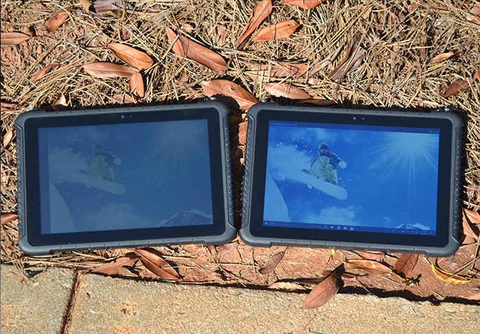 Two Teguar rugged tablets side by side outside showing high brightness model on the right