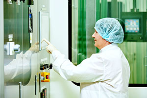 Industrial worker sanitizes an industrial computer