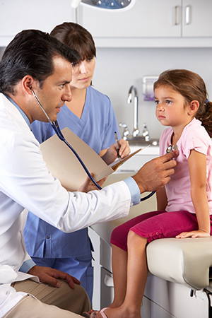Pediatrician and nurse tend to a child patient