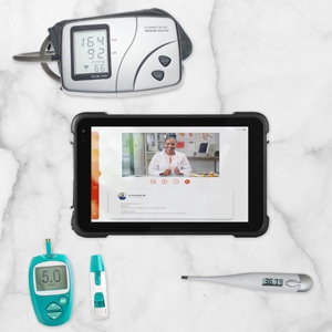 Tablet being used for telehealth while medical instruments surround it