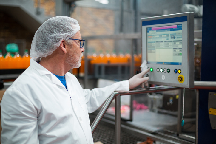 Production worker using an industrial computer