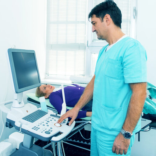 nurse using a workstation on wheels for sonogram