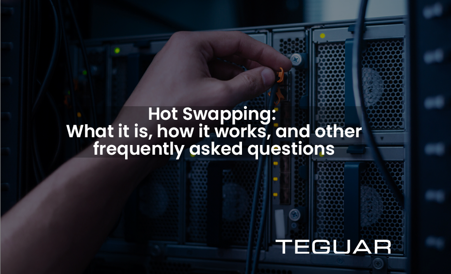 Text reads "Hot swapping: what it is, how it works, and other frequently asked questions." Image behind text: A hand inserts a small plugin into a computer port. Lights on the board indicate the device is on, demonstrating the use of hot swapping. The lighting is dark and cool-toned.
