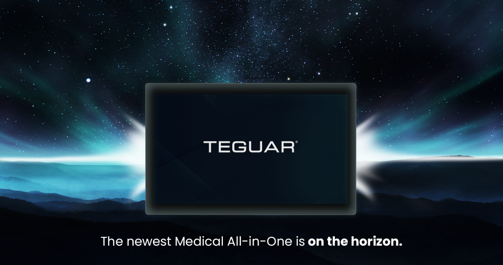A panel PC is silhouetted in black with a bright white light shining behind it. The PC is presented larger than life on a dark mountain horizon with bright stars and cool-toned aurora in the sky. Text on the bottom reads, The newest Medical All-in-One is on the horizon.