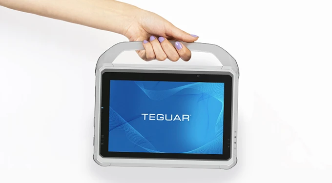 A hand holds the healthcare tablet by its carry handle