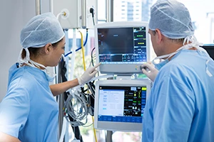 Surgeons using a medical computer during surgery
