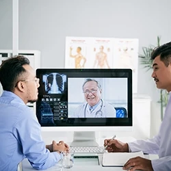 Health professionals use a medical computer for telehealth video conferencing