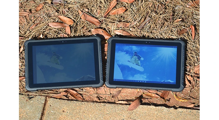 Two TRT-4380 rugged tablets outside on the ground, one with low brightness and one with high brightness