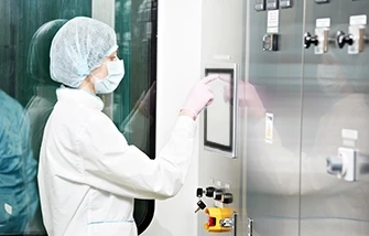 Cleanroom technician using a touchscreen industrial computer