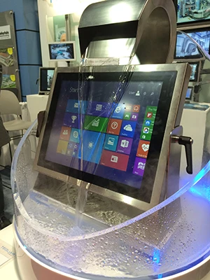 Tradeshow display of a Teguar waterproof touchscreen computer being constantly cascaded by water