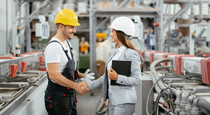 Factory engineer shakes hands with the foreman in the factory